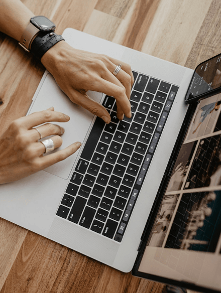 hands-and-laptop-on-desk-image
